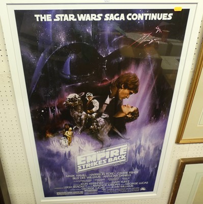 Lot 1135 - A framed film poster for Star Wars The Empire...