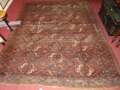 Lot 1440 - An Afghan Ersari woollen carpet, heavily worn,...