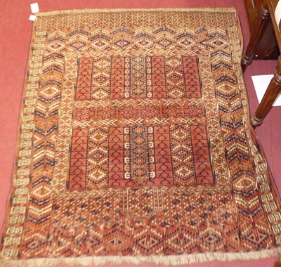 Lot 1442 - A Persian woollen Tekke Ensi red ground rug,...
