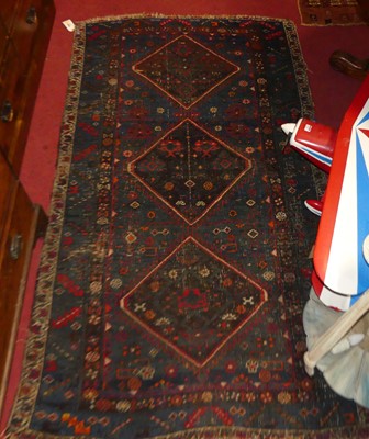 Lot 1450 - A Persian woollen blue ground rug, decorated...