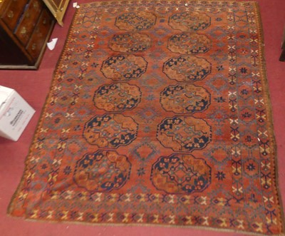 Lot 1458 - A Persian woollen Ersari carpet, having a rust...