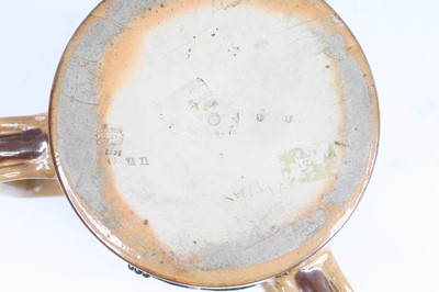 Lot 2056 - A Doulton Lambeth stoneware tyg, on a buff...