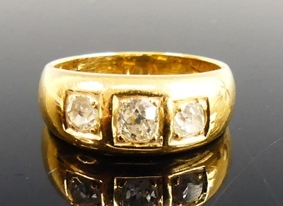 Lot 2263 - A yellow metal diamond three-stone...