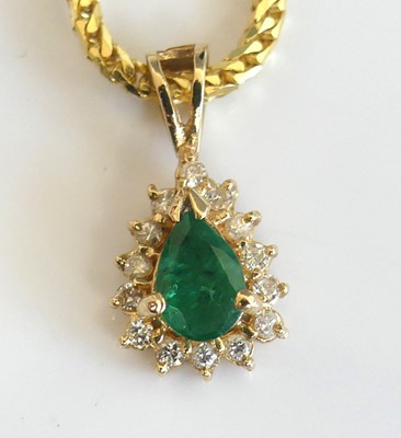 Lot 2278 - A yellow metal, emerald and diamond drop...