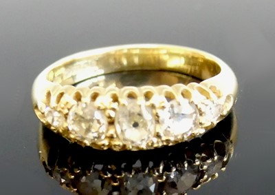 Lot 2257 - An 18ct yellow gold diamond half eternity ring,...