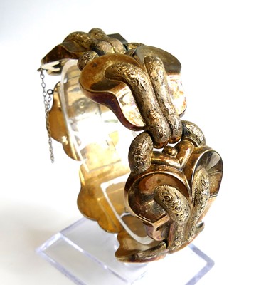 Lot 2321 - A yellow metal hollow bracelet, consisting of...