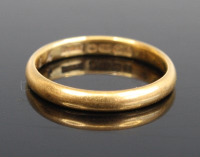 Lot 268 - A 22ct gold court shaped wedding band size L,...