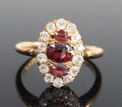 Lot 274 - An 18ct gold garnet and diamond oval cluster...