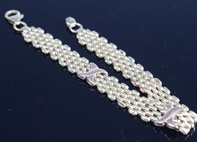 Lot 297 - A modern 9ct two-colour gold flat link...