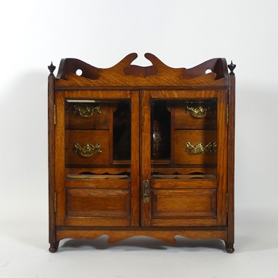 Lot 95 - An Edwardian oak smoker's cabinet, having a...