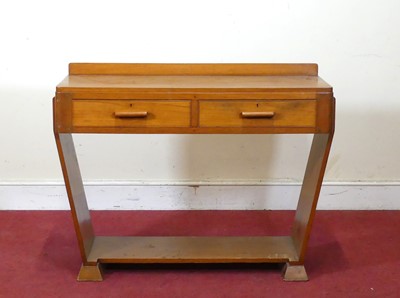 Lot 404 - An Art Deco walnut round-cornered ledgeback...
