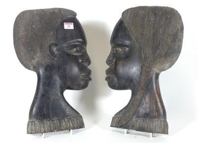 Lot 20 - A pair of African carved hardwood plaques, in...