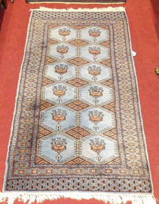 Lot 1119 - A Persian woollen blue ground Bokhara hall rug,...