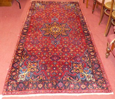 Lot 1140 - A Persian woollen red and blue ground Meshad...