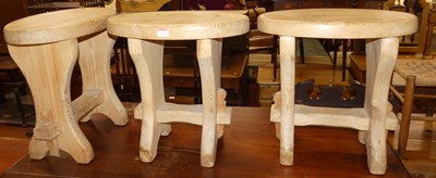 Lot 1172 - A set of three pine oval topped milking stools,...