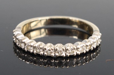 Lot 323 - A yellow metal half hoop eternity ring, set...