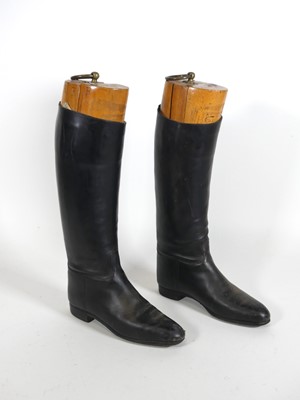 Lot 130 - A pair of leather riding boots, with boot...