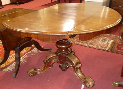Lot 1238 - A Victorian walnut circular drop-flap pedestal...
