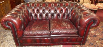 Lot 1249 - A contemporary ox blood red leather buttoned...