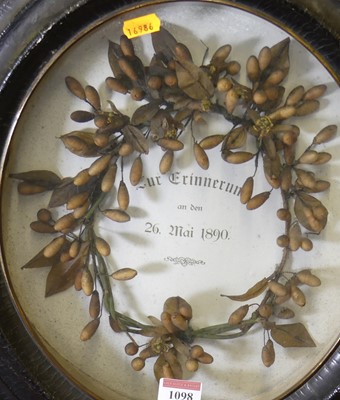 Lot 1098 - An oval framed and glazed memorial wreath of...