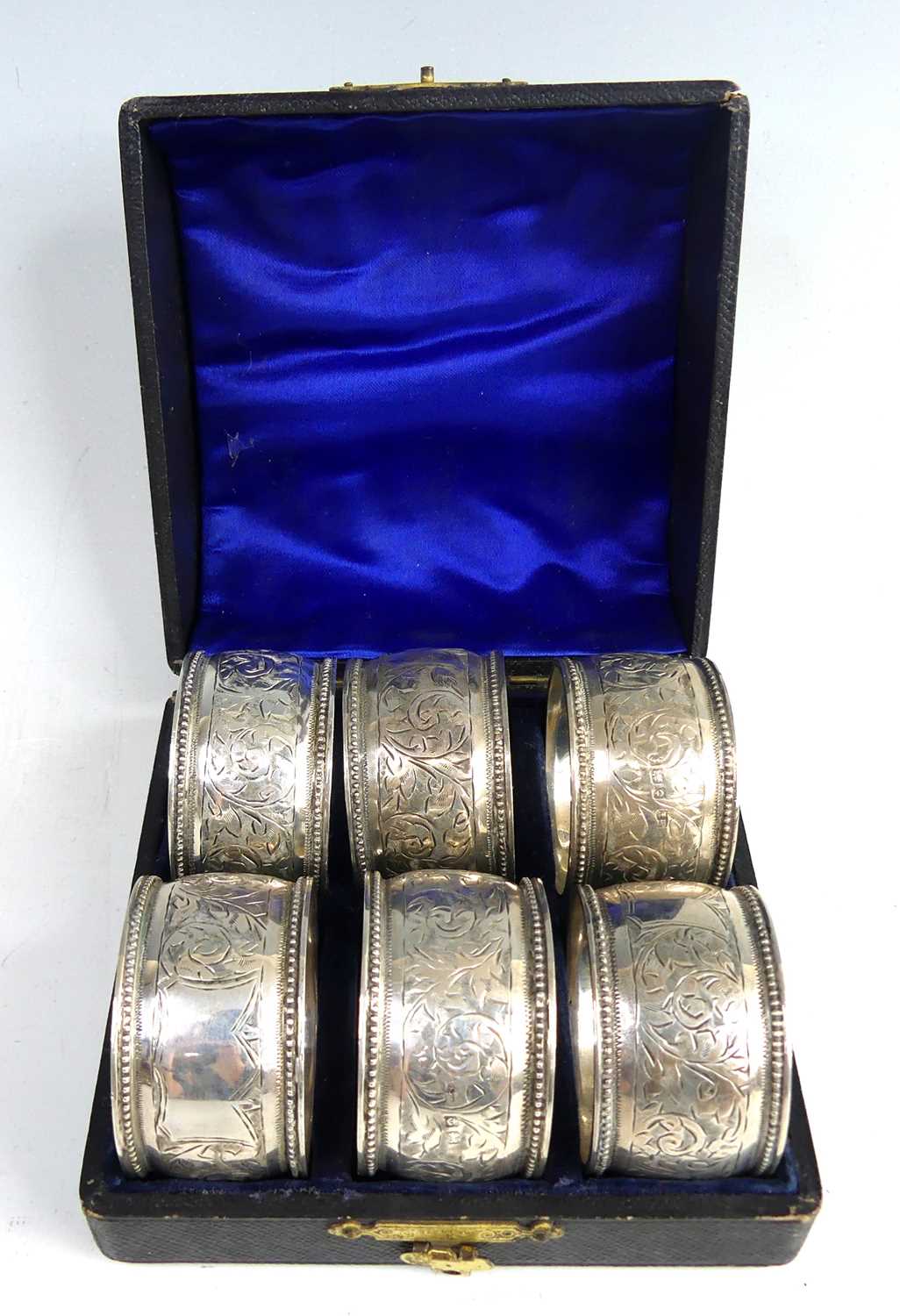 Lot 2105 - A cased set of six Edwardian silver napkin...