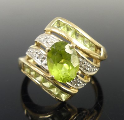 Lot 2631 - A 9ct yellow and white gold green peridot and...