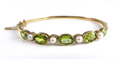 Lot 2295 - A 9ct yellow gold, peridot and pearl hinged...