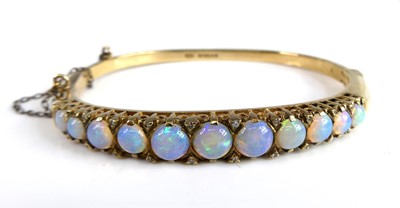 Lot 2294 - A 9ct yellow gold, opal and diamond hinged...