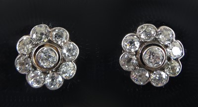 Lot 2328 - A pair of white metal diamond circular cluster...