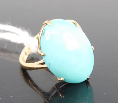 Lot 406 - A yellow metal turquoise ring, the oval...