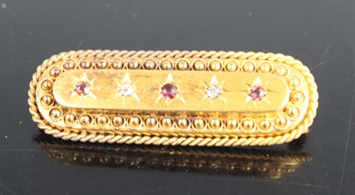 Lot 327 - A yellow metal ruby and diamond oblong bar...