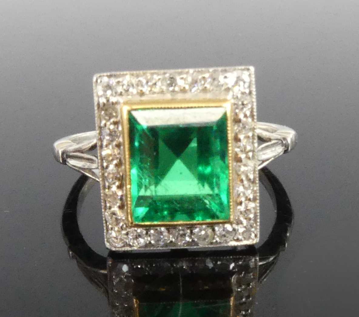 Lot 2331 - A white and yellow metal, emerald and diamond...