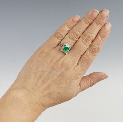 Lot 2331 - A white and yellow metal, emerald and diamond...