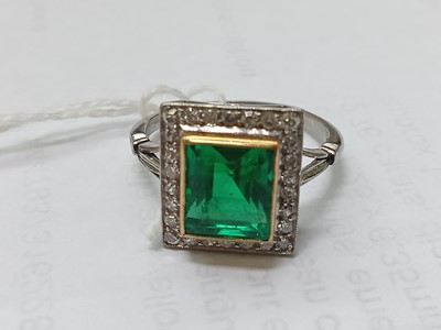 Lot 2331 - A white and yellow metal, emerald and diamond...