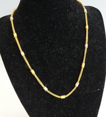Lot 2317 - A 22ct gold beaded mesh link necklace, having...