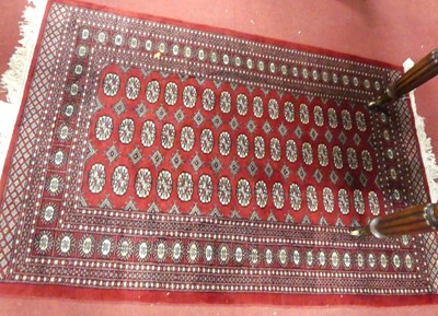 Lot 1169 - A Persian woollen Bokhara red ground rug, 127...