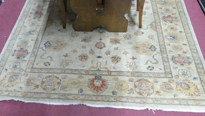 Lot 1162 - A Persian woollen Oushak rug, decorated with...