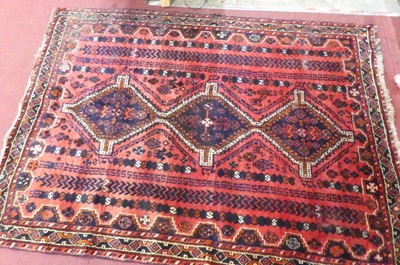 Lot 1157 - An Afghan woollen red ground rug (with...