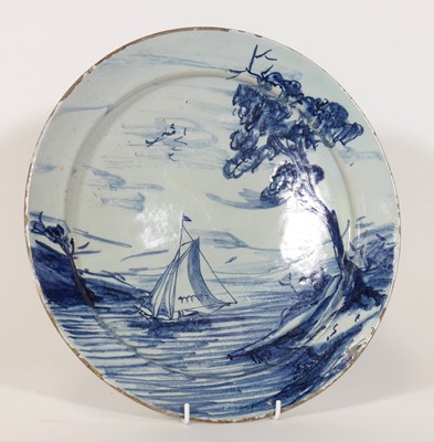 Lot 7 - An 18th century Delft blue and white charger,...