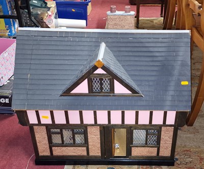 Lot 1602 - A painted two-storey dolls house in tudor...