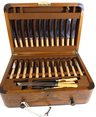 Lot 157 - An Art Deco walnut cased canteen of silver...