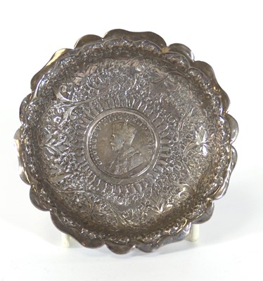 Lot 184 - An Indian white metal dish, repousse decorated...