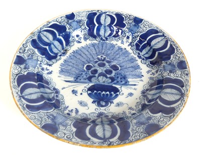 Lot 120 - An 18th century Delft blue and white charger,...