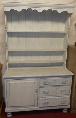 Lot 1140 - A rustic painted pine kitchen dresser, having...