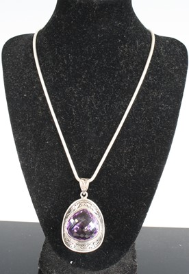 Lot 335 - A modern silver and pear cut amethyst pendant...