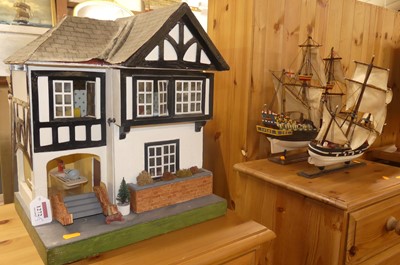 Lot 1272 - A painted two-storey dolls house, together...
