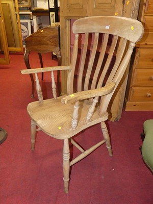 Lot 1334 - An early 20th century elm and beech slat back...