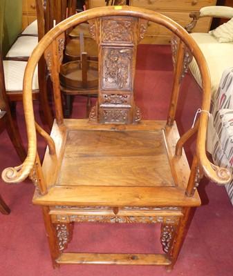 Lot 1340 - An Eastern stained elm relief carved horseshoe...