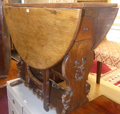 Lot 1352 - A rustic south German joined oak drop leaf...