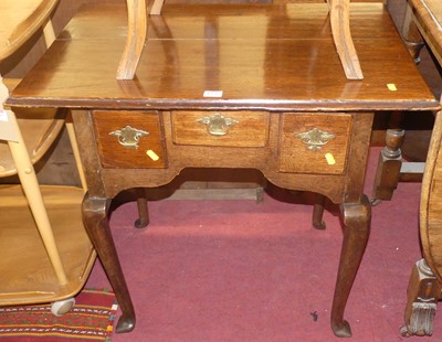 Lot 1359 - A George III oak three-drawer lowboy, raised...
